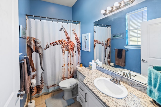 bathroom featuring tile patterned flooring, vanity, toilet, and curtained shower