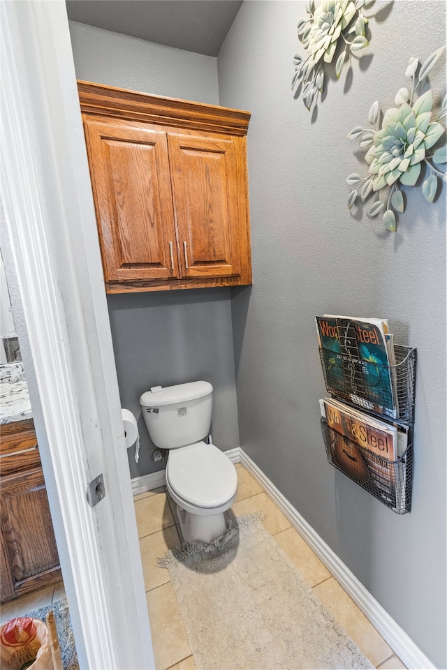 bathroom with tile patterned flooring and toilet