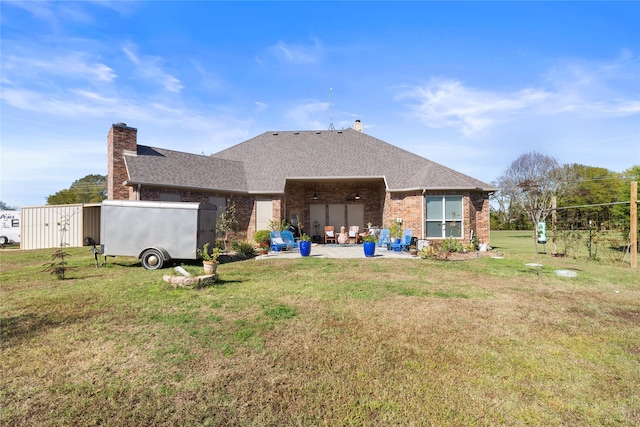 back of property with a patio area and a yard