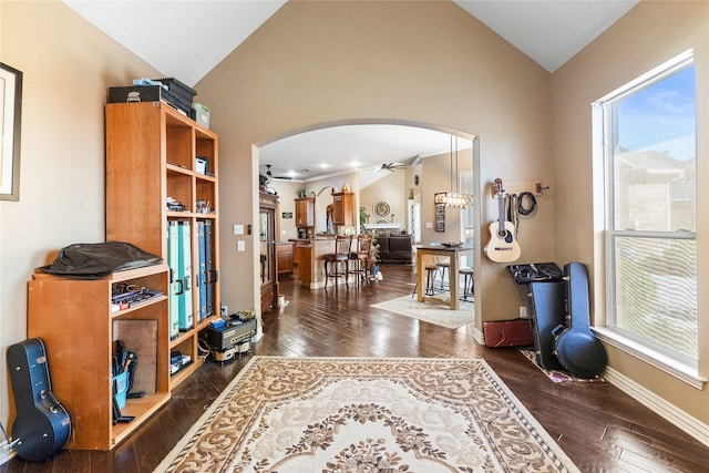 foyer entrance featuring ceiling fan, dark wood-type flooring, and lofted ceiling