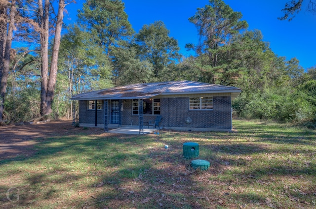 ranch-style home with a patio and a front lawn