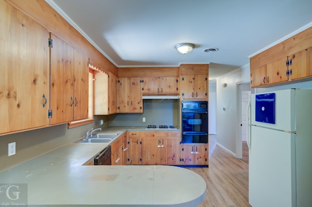 kitchen with kitchen peninsula, ornamental molding, sink, black appliances, and light hardwood / wood-style flooring