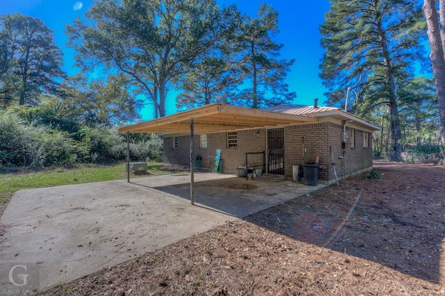 rear view of property with a carport