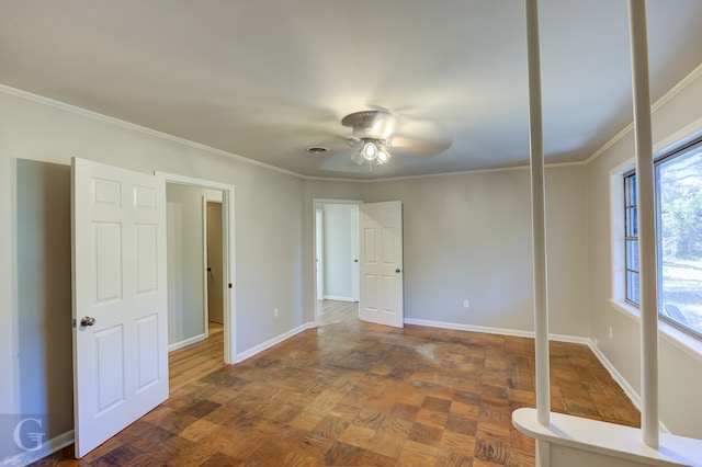 spare room with dark parquet floors, ceiling fan, and ornamental molding