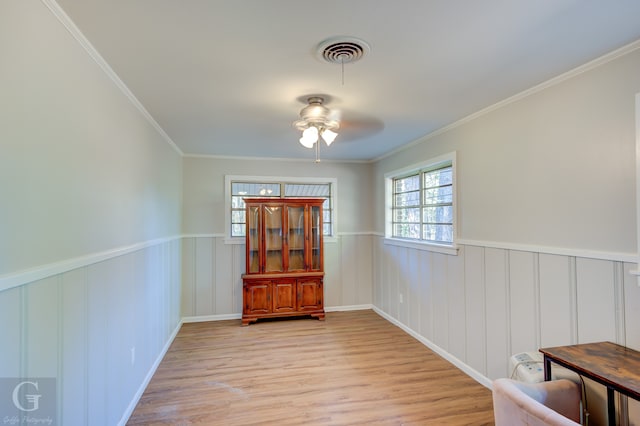 interior space with ceiling fan, light hardwood / wood-style floors, and crown molding