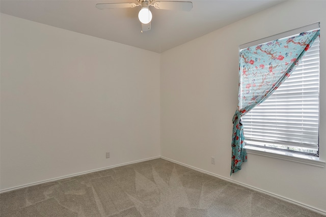 carpeted spare room featuring ceiling fan