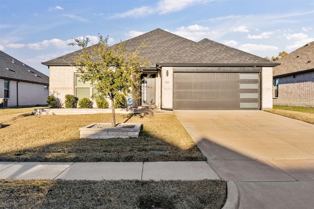 view of front of house with a front yard and a garage