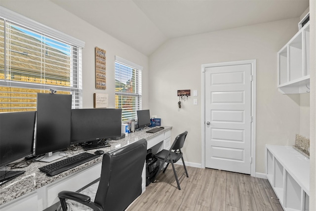 office with vaulted ceiling and light hardwood / wood-style flooring