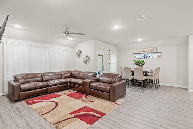 living room with light wood-type flooring, ceiling fan, and lofted ceiling