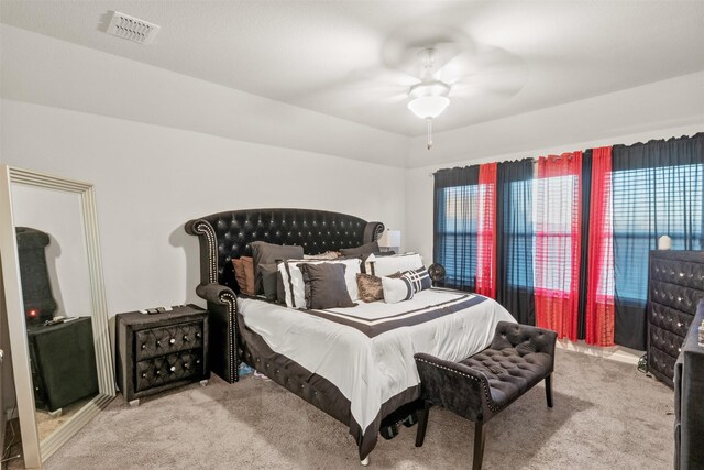 bedroom featuring light carpet and ceiling fan