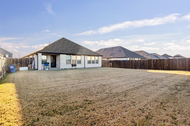 rear view of property with a yard