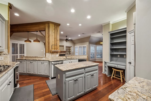 kitchen with sink, ornamental molding, tasteful backsplash, a center island, and dark hardwood / wood-style flooring