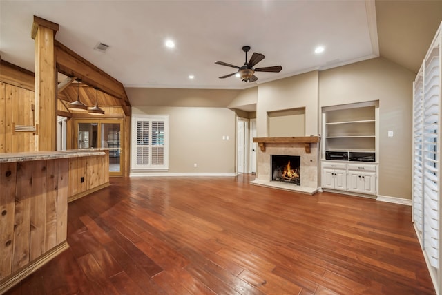 unfurnished living room featuring dark hardwood / wood-style floors, lofted ceiling, and ornamental molding