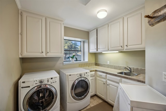 laundry room with washing machine and dryer, cabinets, sink, and light tile patterned flooring