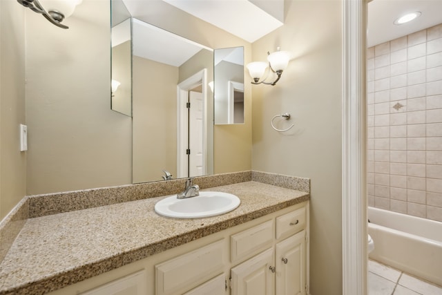 full bathroom with toilet, vanity, tiled shower / bath, and tile patterned flooring