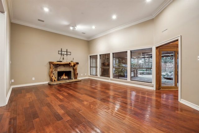 unfurnished living room with ornamental molding and hardwood / wood-style flooring