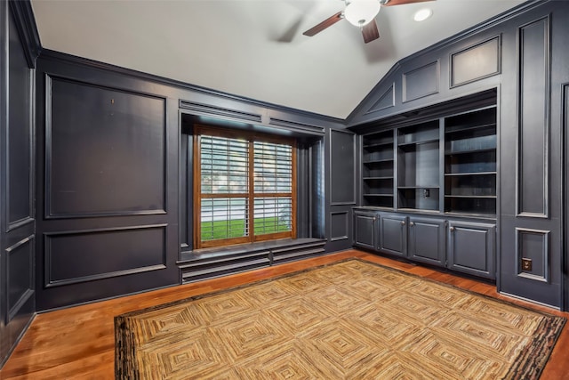 interior space with light hardwood / wood-style floors, lofted ceiling, ceiling fan, and built in features