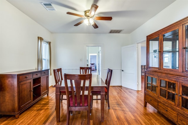 dining room with dark hardwood / wood-style floors, a wealth of natural light, and ceiling fan