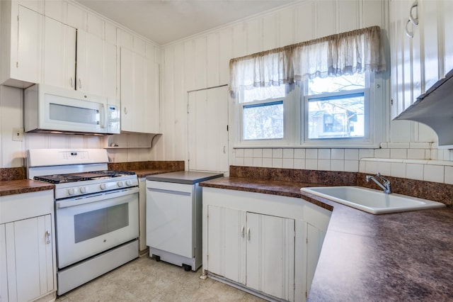 kitchen with crown molding, sink, white cabinets, and white appliances