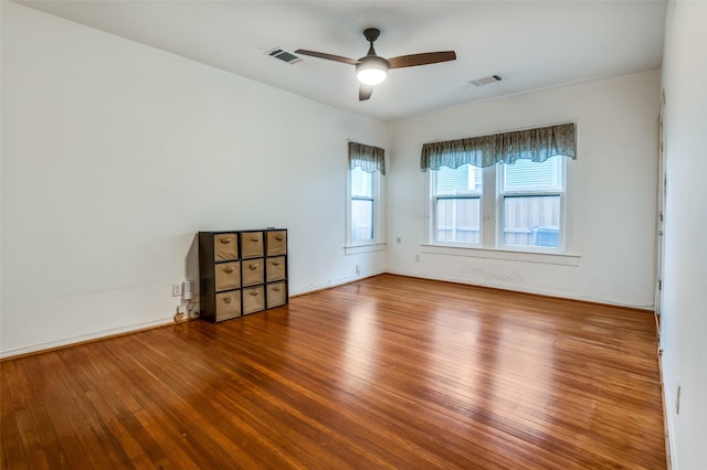 spare room featuring hardwood / wood-style flooring and ceiling fan