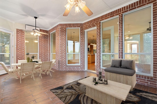 sunroom featuring ceiling fan