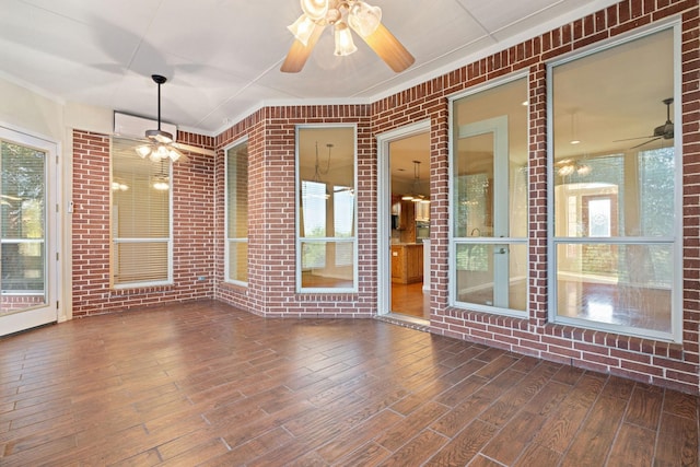 unfurnished sunroom with ceiling fan