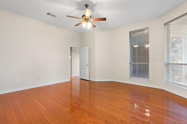 empty room featuring hardwood / wood-style flooring and ceiling fan