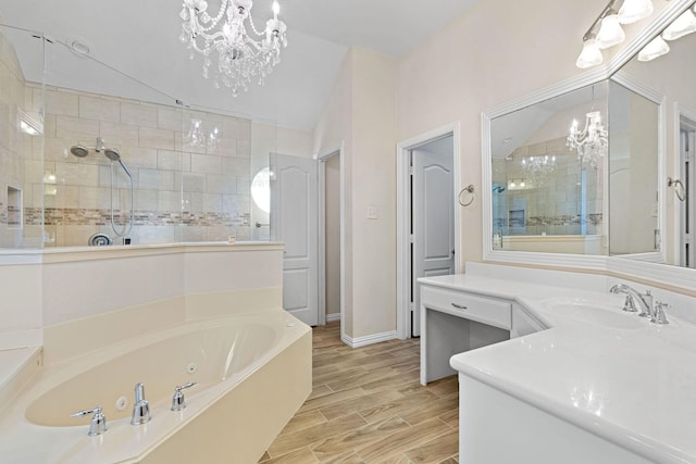 bathroom with hardwood / wood-style flooring, a chandelier, vanity, and plus walk in shower