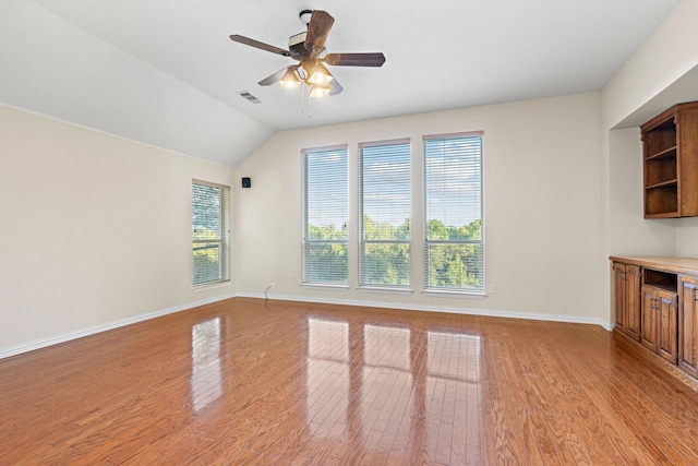 unfurnished living room featuring ceiling fan, lofted ceiling, and light hardwood / wood-style floors