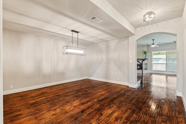 empty room with dark hardwood / wood-style floors and ceiling fan