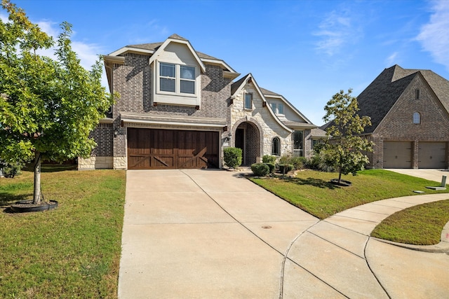 view of front of house featuring a front yard and a garage