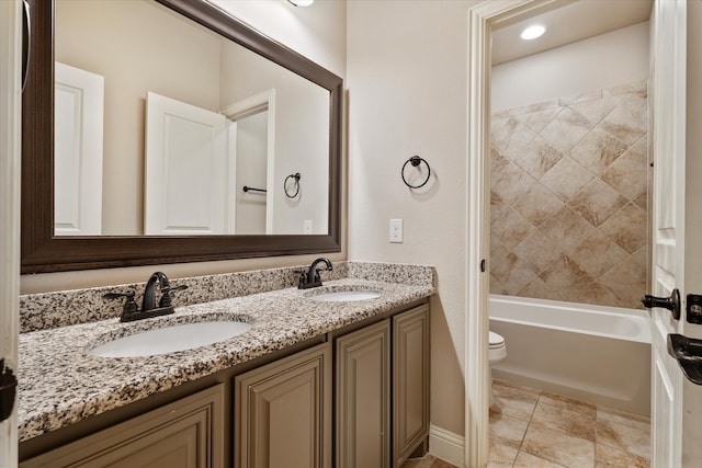 full bathroom with vanity, toilet, and tiled shower / bath combo