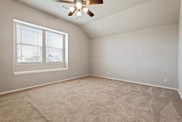 additional living space with ceiling fan, lofted ceiling, and light carpet