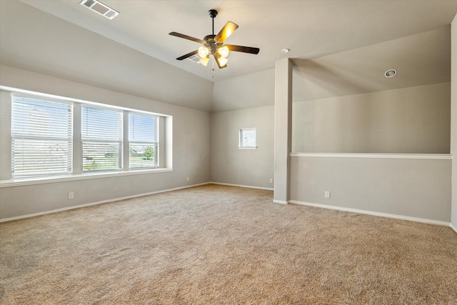 carpeted spare room featuring ceiling fan and high vaulted ceiling