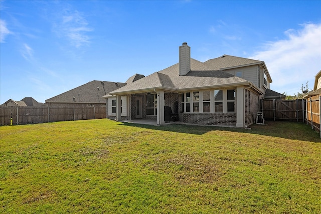 back of property featuring a yard and a patio area