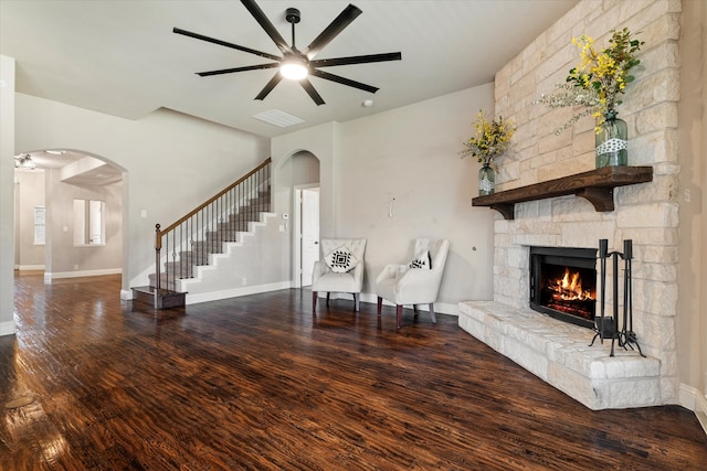 unfurnished living room with ceiling fan, a fireplace, and hardwood / wood-style flooring