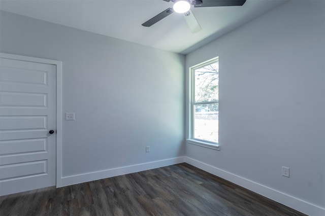 empty room with dark hardwood / wood-style flooring and ceiling fan