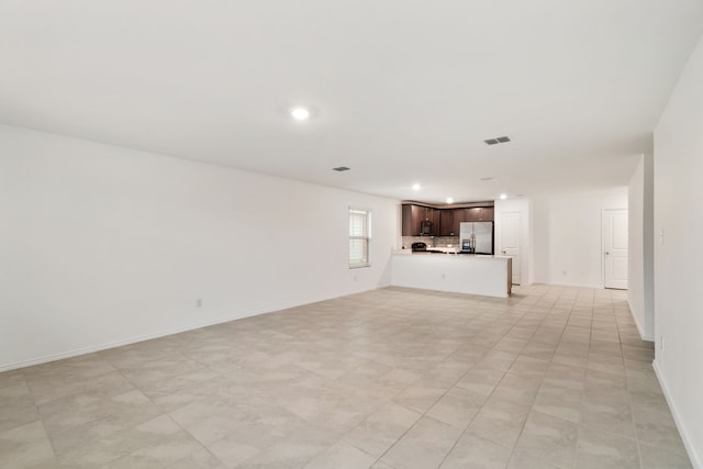 unfurnished living room with light tile patterned floors