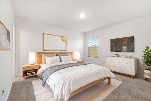 bedroom featuring light colored carpet