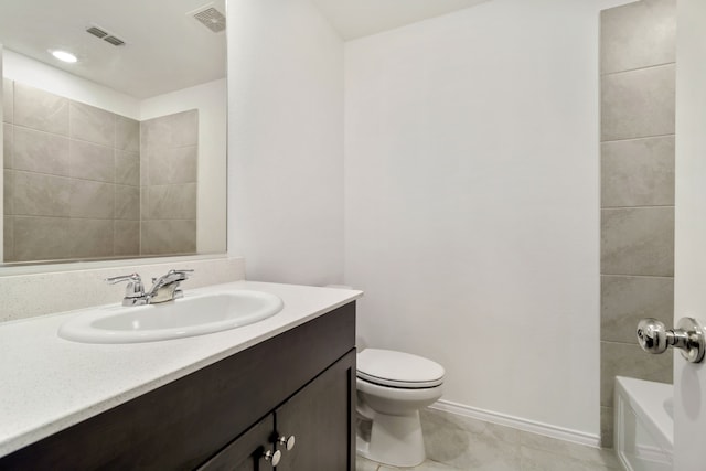 full bathroom featuring toilet, vanity, tiled shower / bath, and tile patterned floors