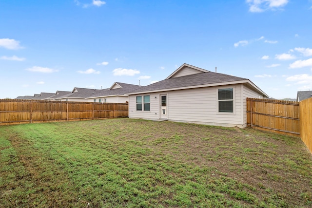 rear view of house with a lawn