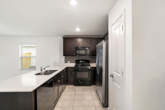 kitchen with light tile patterned flooring, sink, black appliances, kitchen peninsula, and tasteful backsplash