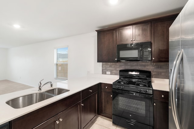 kitchen featuring light tile patterned flooring, sink, black appliances, kitchen peninsula, and decorative backsplash