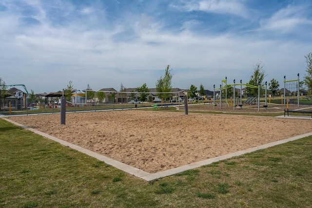 view of home's community featuring volleyball court and a lawn