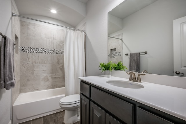 full bathroom with shower / tub combo with curtain, vanity, wood-type flooring, and toilet