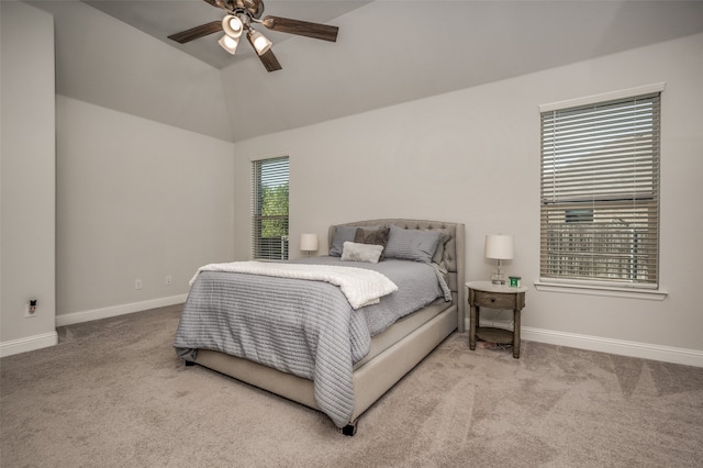 carpeted bedroom with vaulted ceiling and ceiling fan