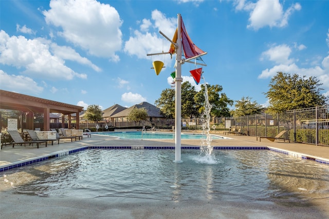 view of pool with a patio area and pool water feature