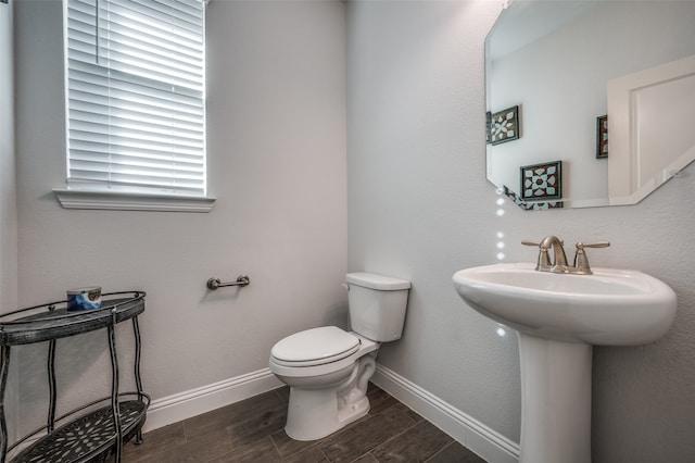 bathroom with hardwood / wood-style floors and toilet