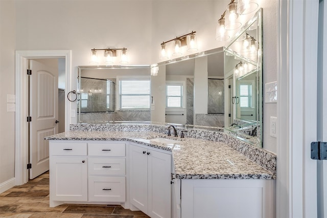 bathroom featuring hardwood / wood-style floors, vanity, and walk in shower