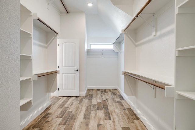 spacious closet featuring light hardwood / wood-style floors